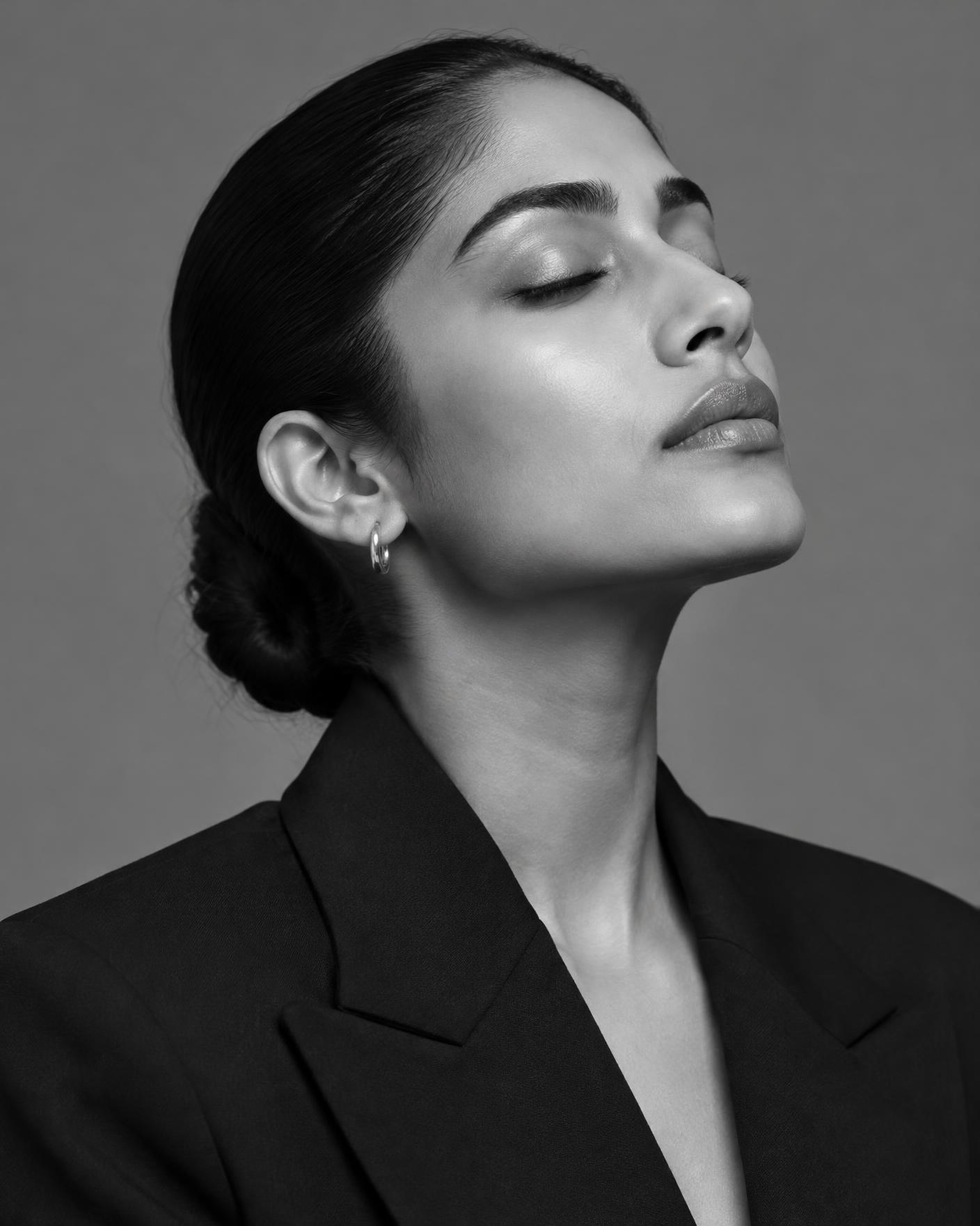 Black and white editorial portrait showing smooth, clear skin